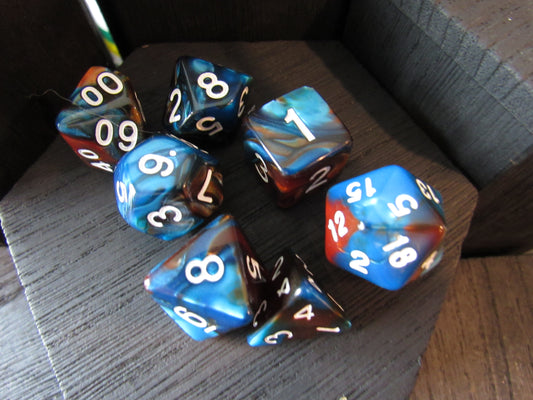 Set of polyhedral dice with blue and red colors on a wooden surface