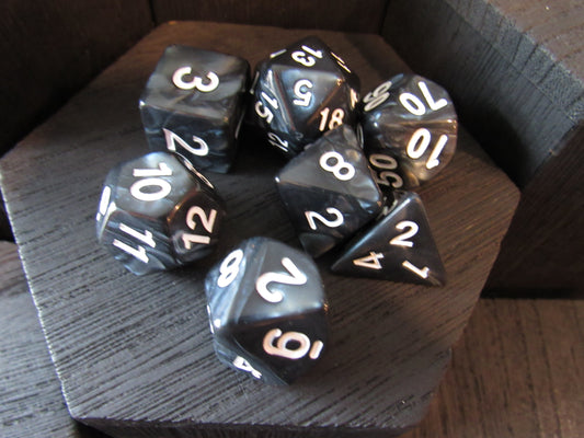 Set of polyhedral dice on a wooden surface