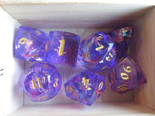 Set of purple polyhedral dice with gold numbers in a wooden box gem gemstone cut faceted resin dice