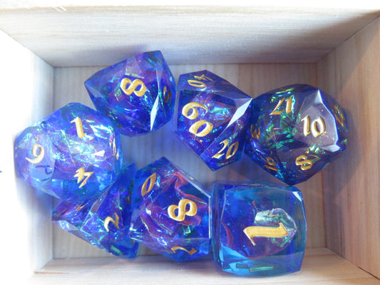 Set of blue polyhedral dice with gold numbers in a wooden box gem gemstone crystal cut faceted resin dice