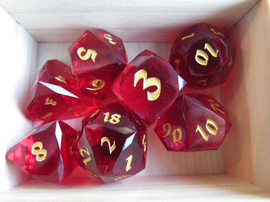 Red dice with gold numbers in a cardboard box gem gemstone crystal cut faceted resin dice