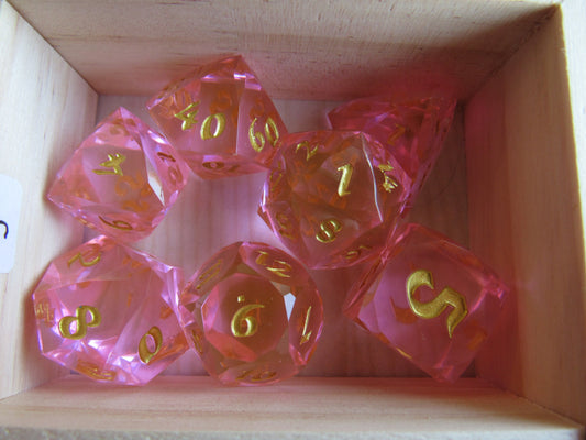 Set of pink polyhedral dice with gold numbers in a wooden box gem gemstone crystal cut faceted resin dice