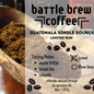 Battle Brew Coffee Guatemala single source coffee packaging with ground coffee in a scoop.