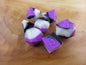 Purple, White, and Black Silicone Dice