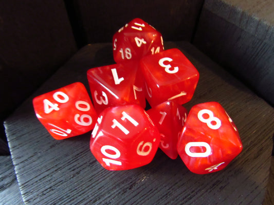 Red dice with white numbers on a wooden surface