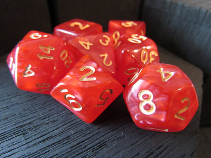 Red dice with gold numbers on a textured surface