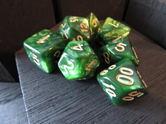 Green dice with gold numbers on a textured surface