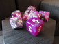 Purple and white dice set on a wooden surface