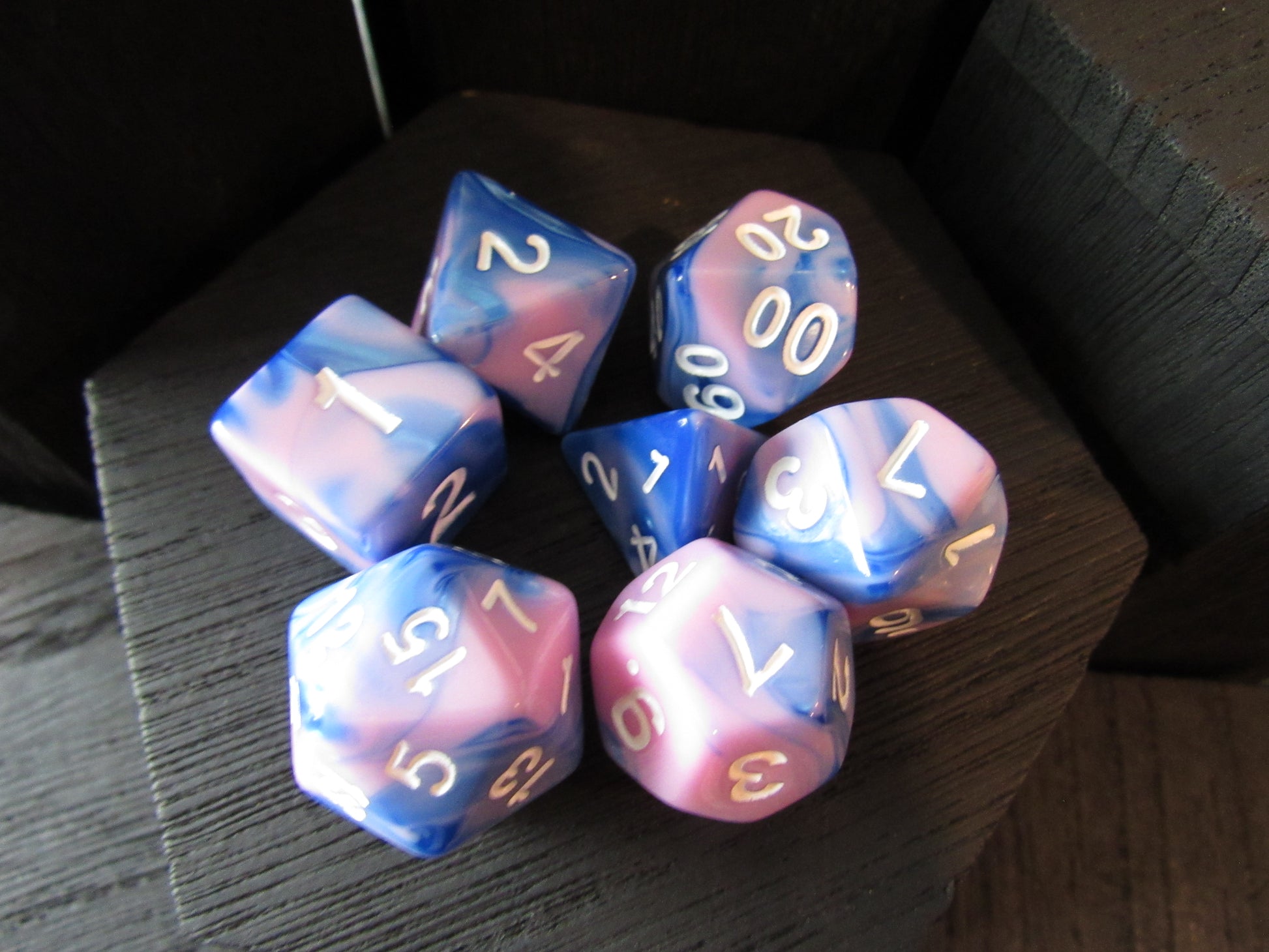 Set of colorful polyhedral dice on a dark surface