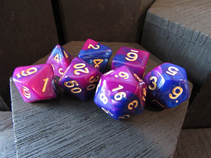 Purple and blue polyhedral dice set on a wooden surface