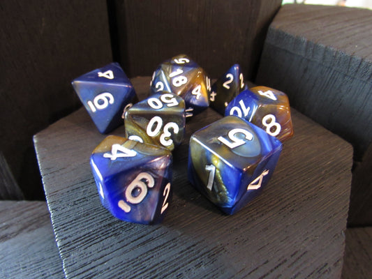 Set of blue and orange polyhedral dice on a wooden surface