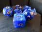 Blue dice with gold numbers on a wooden surface