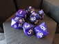 Purple polyhedral dice set on a wooden surface