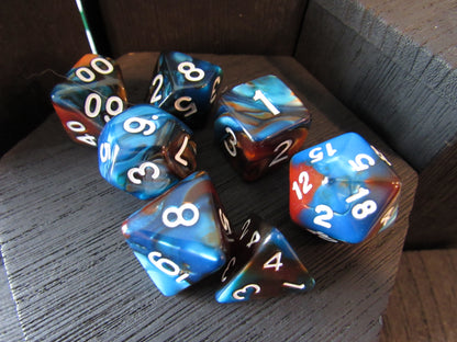 Set of blue and brown polyhedral dice on a wooden surface