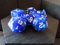 Blue polyhedral dice set with white numbers on a wooden surface