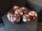 Set of polyhedral dice with brown and white colors on a dark surface