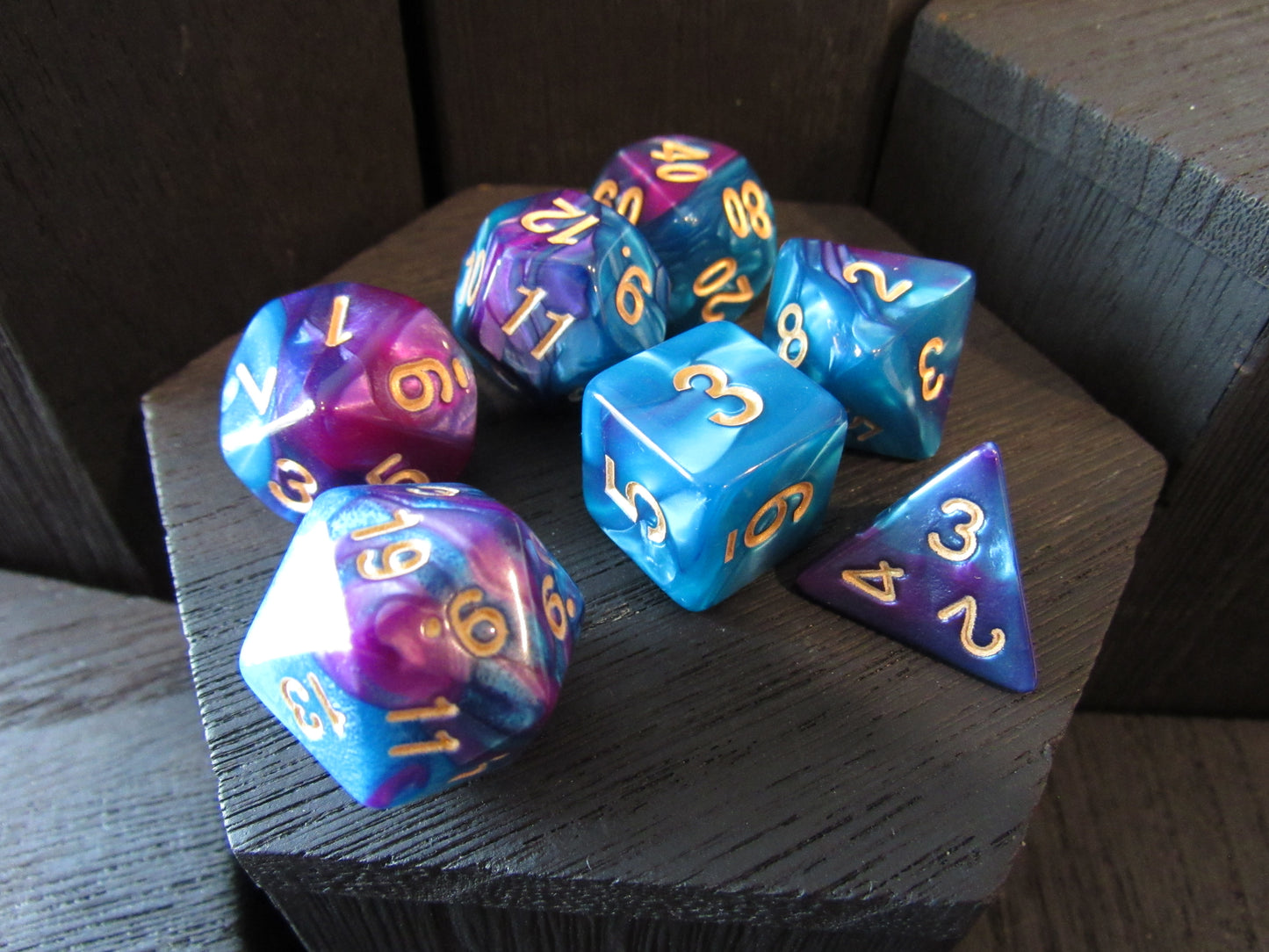 Set of colorful polyhedral dice on a wooden surface