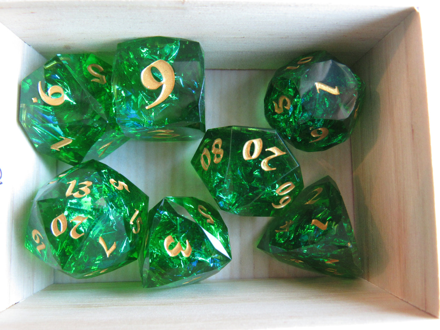 Green dice with gold numbers in a wooden box gem gemstone crystal cut faceted resin dice