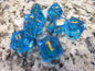 Blue dice with gold numbers on a marble surface gem gemstone cut faceted resin dice 