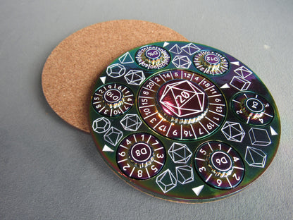 Circular die with various polyhedral dice designs on a gray surface rainbow plated dungeons and dragons
