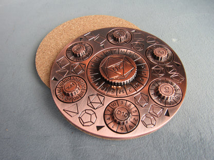 Copper-colored circular object with geometric designs on a gray surface dungeons and dragons spinner dice